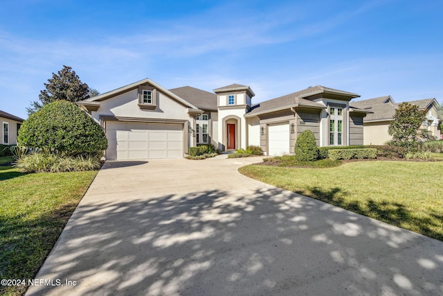 view of front of house with a front yard and a garage