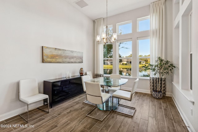 dining room with a chandelier and a water view