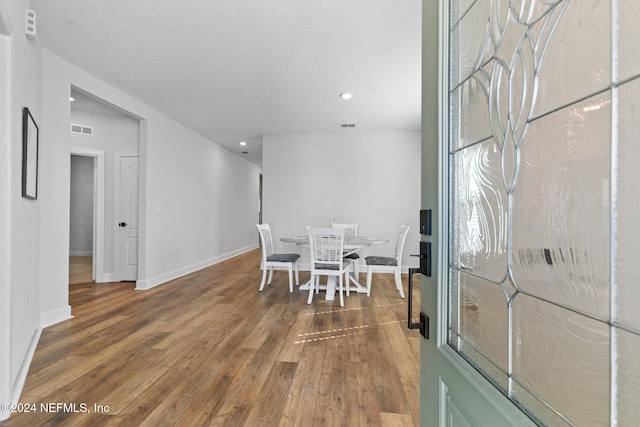 dining area featuring hardwood / wood-style floors and a textured ceiling