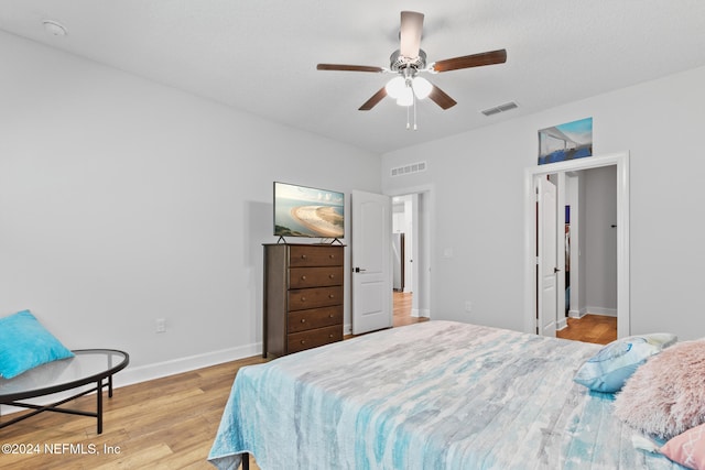 bedroom with ceiling fan and light wood-type flooring