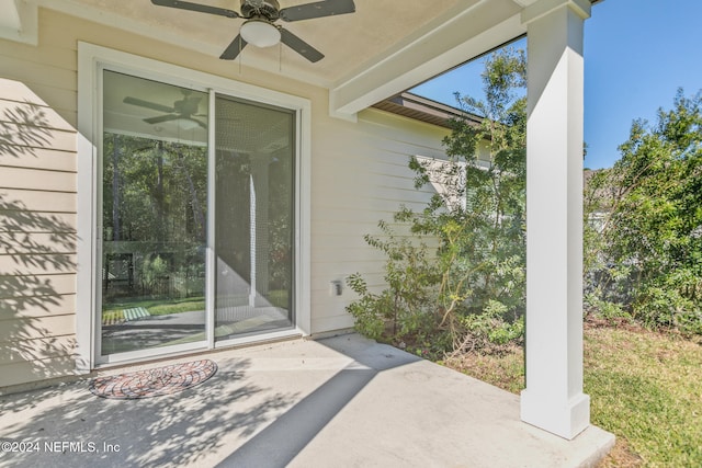 entrance to property featuring ceiling fan and a patio