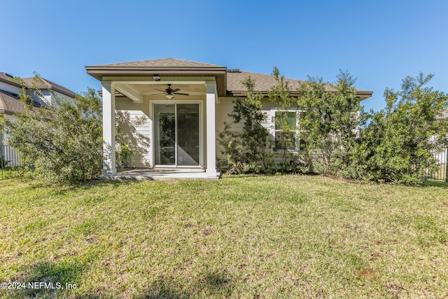 view of exterior entry featuring a lawn and ceiling fan