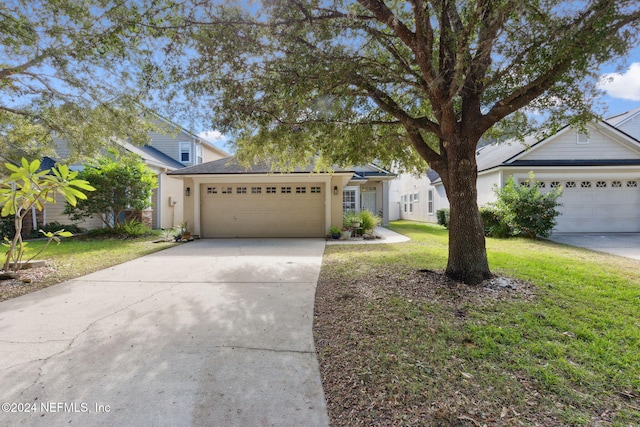 view of front of house featuring a front yard and a garage