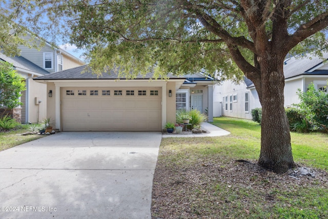 view of front facade featuring a garage and a front lawn