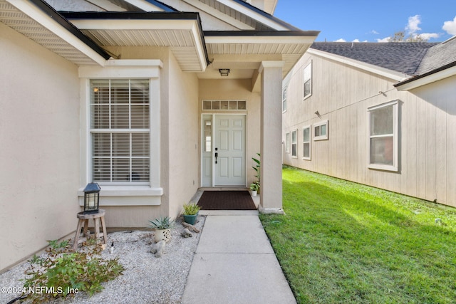 doorway to property with a yard