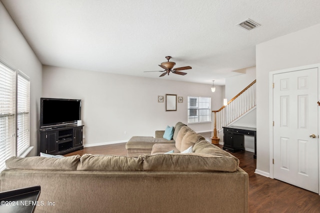 living room featuring ceiling fan and dark hardwood / wood-style flooring