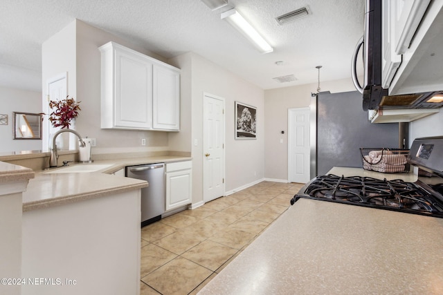 kitchen featuring stainless steel dishwasher, gas range, a textured ceiling, sink, and white cabinetry