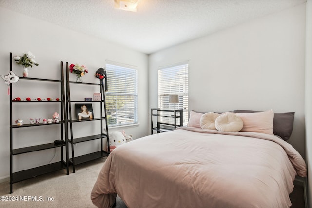 carpeted bedroom featuring a textured ceiling