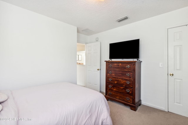 carpeted bedroom featuring a textured ceiling