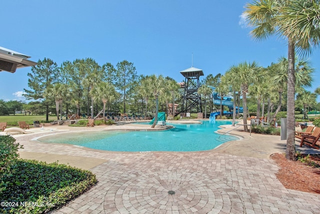 view of swimming pool featuring a patio and a water slide