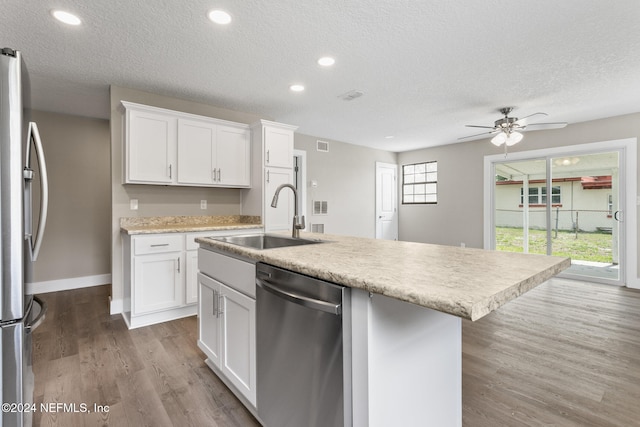 kitchen featuring a kitchen island with sink, sink, light hardwood / wood-style floors, white cabinetry, and stainless steel appliances