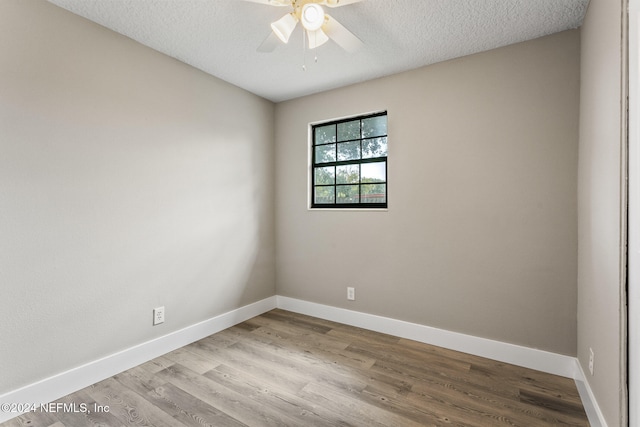 spare room with ceiling fan, a textured ceiling, and light wood-type flooring