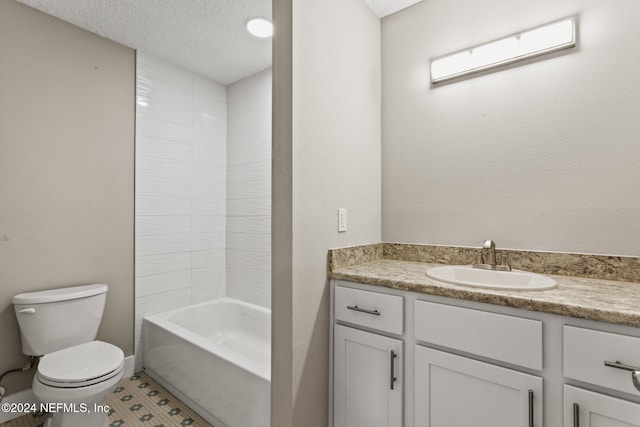 full bathroom with washtub / shower combination, tile patterned flooring, a textured ceiling, toilet, and vanity