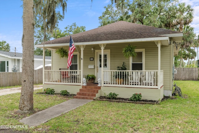 bungalow-style house featuring a front lawn and a porch