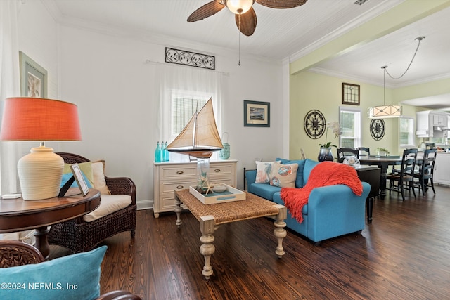 living room with crown molding, ceiling fan, and dark wood-type flooring