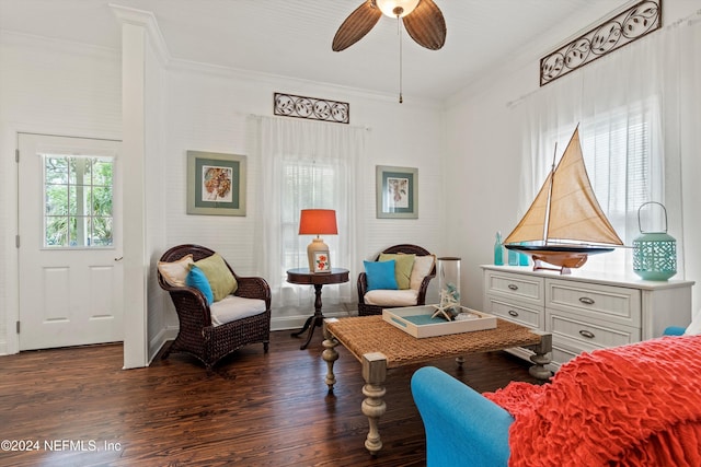 living area featuring crown molding, dark hardwood / wood-style floors, and ceiling fan