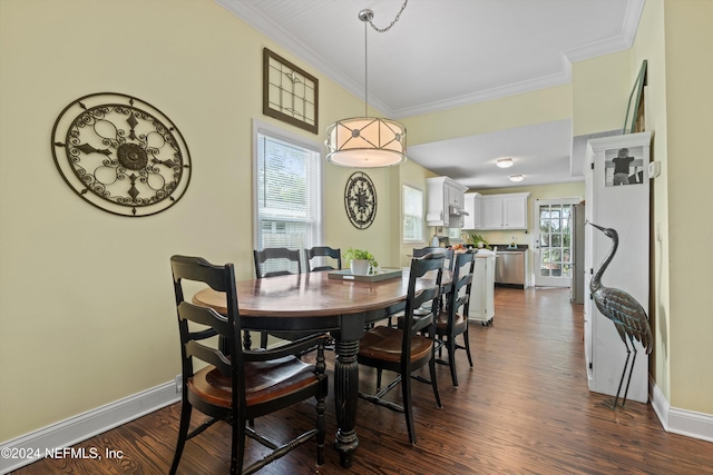 dining area with dark wood-type flooring and crown molding