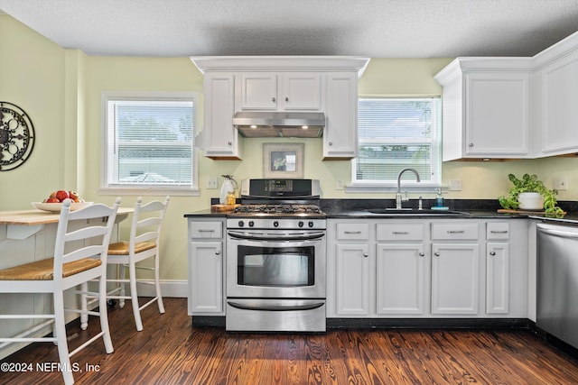 kitchen featuring sink, stainless steel appliances, dark hardwood / wood-style floors, a textured ceiling, and white cabinets