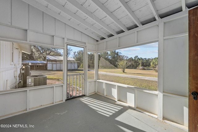 unfurnished sunroom with lofted ceiling with beams