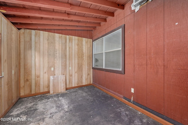 unfurnished room with wooden ceiling, wooden walls, and lofted ceiling with beams