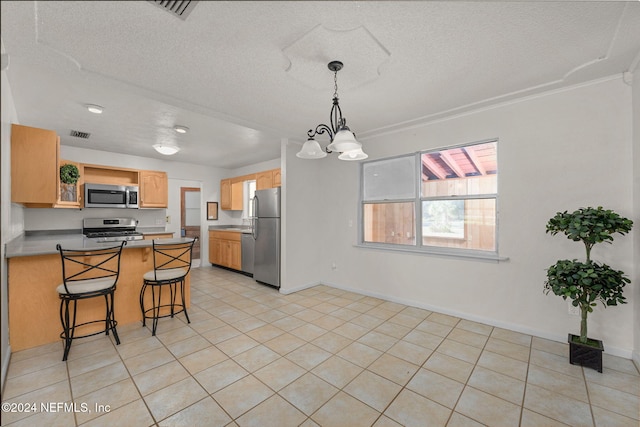 kitchen with light tile patterned floors, kitchen peninsula, light brown cabinets, and stainless steel appliances