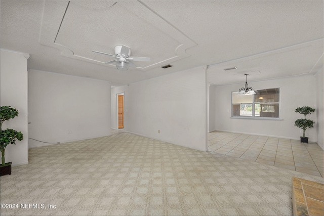 tiled spare room featuring a textured ceiling and ceiling fan with notable chandelier