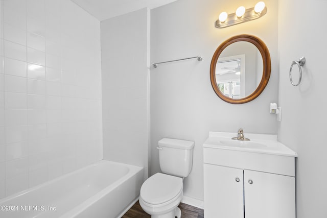 full bathroom featuring shower / bathing tub combination, hardwood / wood-style floors, vanity, and toilet