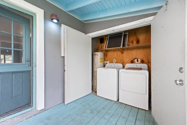 clothes washing area with electric water heater, light wood-type flooring, separate washer and dryer, and wood ceiling