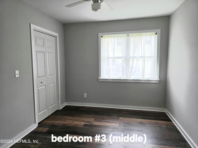 unfurnished bedroom featuring dark hardwood / wood-style flooring, a closet, and ceiling fan