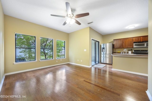532 Dry Branch Way, Saint Johns, FL 32259 - kitchen featuring appliances with stainless steel finishes, ceiling fan, brown cabinetry, and dark wood-style flooring