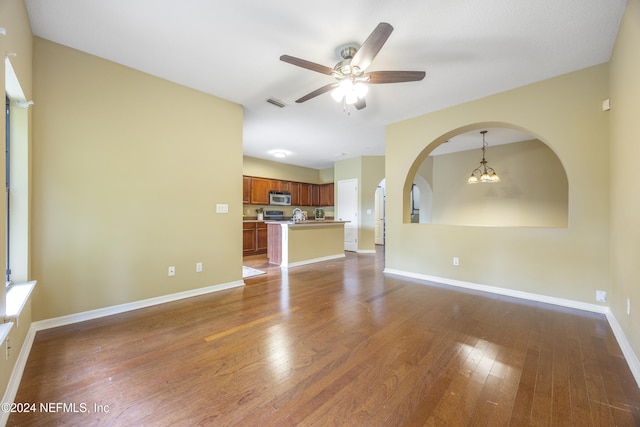 532 Dry Branch Way, Saint Johns, FL 32259 - unfurnished living room with ceiling fan, wood finished floors, arched walkways, and a chandelier