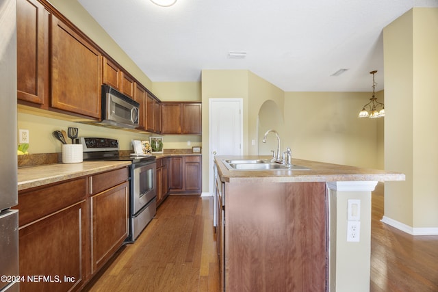 532 Dry Branch Way, Saint Johns, FL 32259 - kitchen with appliances with stainless steel finishes, dark wood-type flooring, a center island with sink, and light countertops
