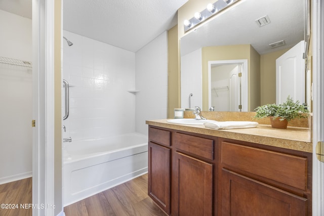 532 Dry Branch Way, Saint Johns, FL 32259 - full bathroom featuring wood finished floors, vanity,  shower combination, a spacious closet, and a textured ceiling