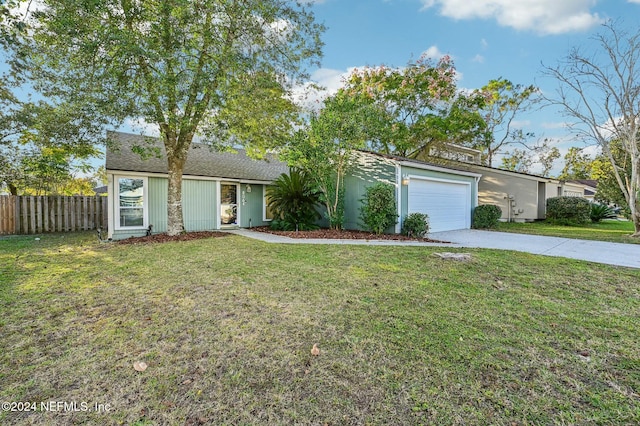 ranch-style house with a garage and a front yard