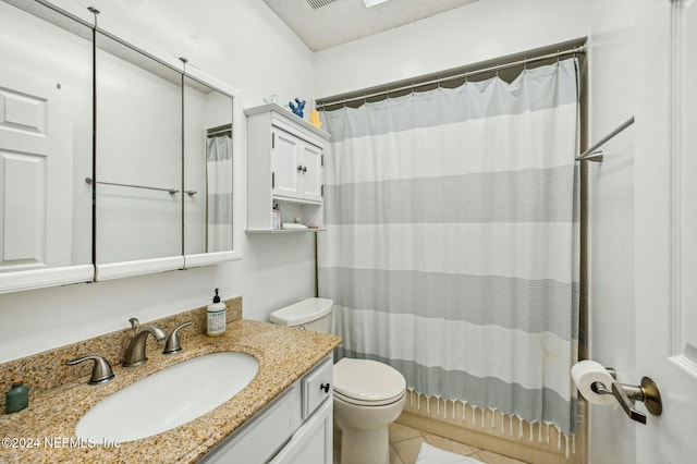 bathroom featuring tile patterned floors, vanity, and toilet