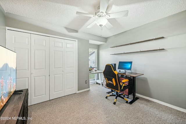 office with ceiling fan, light colored carpet, and a textured ceiling