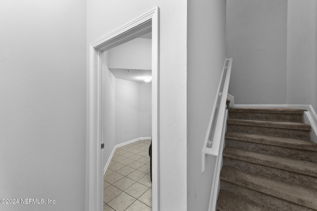 staircase featuring tile patterned floors