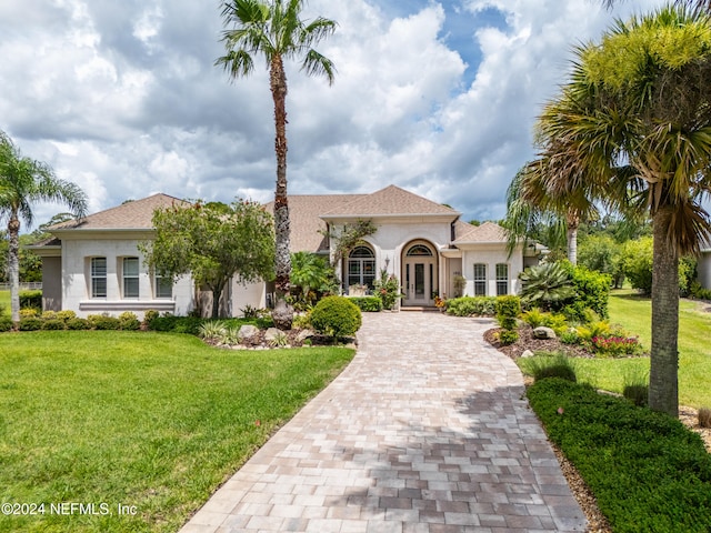 mediterranean / spanish-style home featuring a front lawn