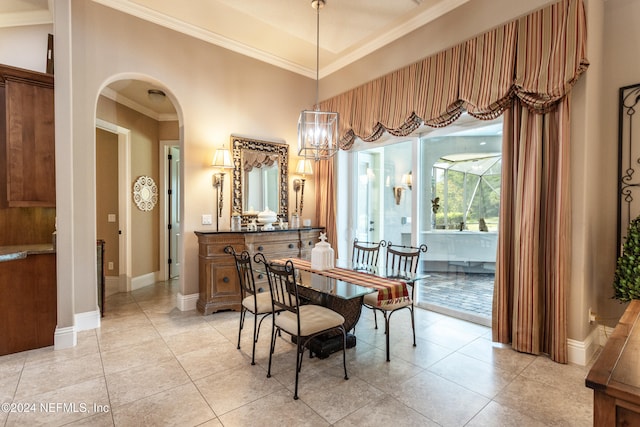 dining space featuring crown molding and light tile patterned floors