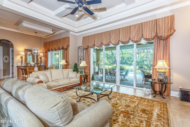 living room with light tile patterned flooring, ornamental molding, and a wealth of natural light