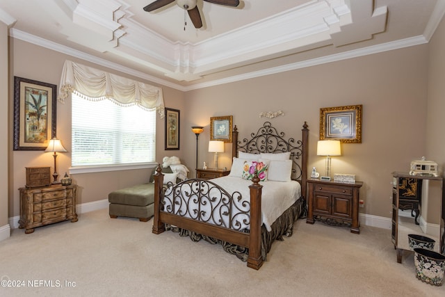 bedroom featuring a tray ceiling, crown molding, ceiling fan, and light colored carpet