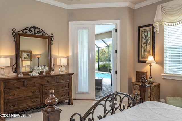 bedroom with access to exterior, carpet floors, and crown molding