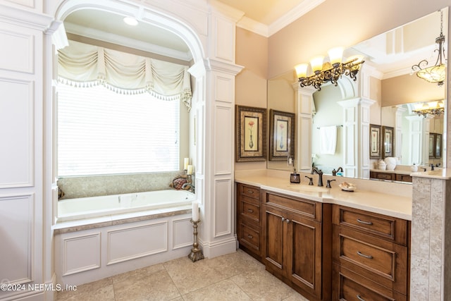 bathroom with a washtub, vanity, decorative columns, and crown molding