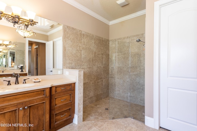 bathroom with crown molding, a chandelier, a textured ceiling, tiled shower, and vanity