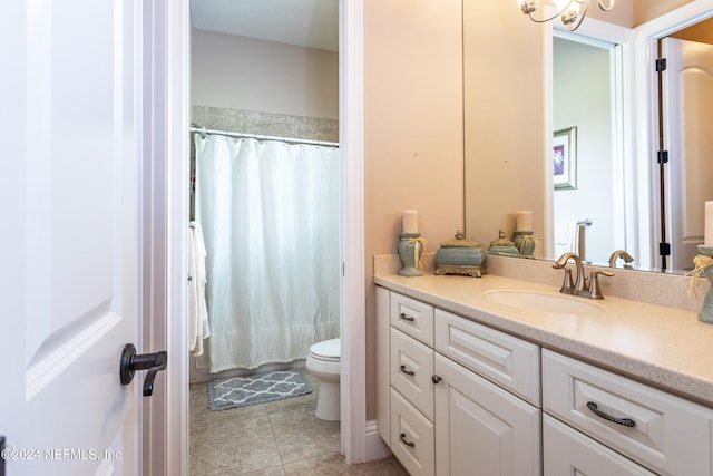 bathroom with tile patterned flooring, vanity, and toilet