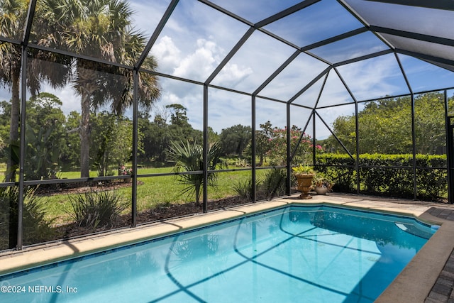 view of swimming pool featuring glass enclosure