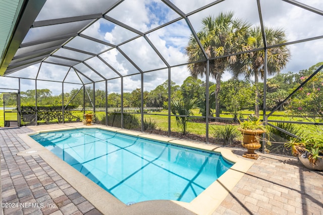 view of pool with a patio and a lanai