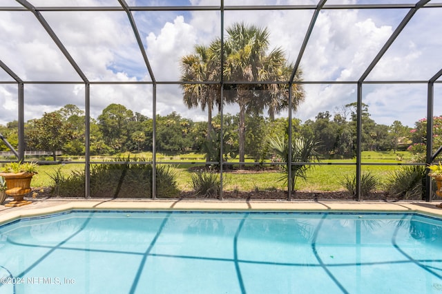 view of swimming pool with glass enclosure