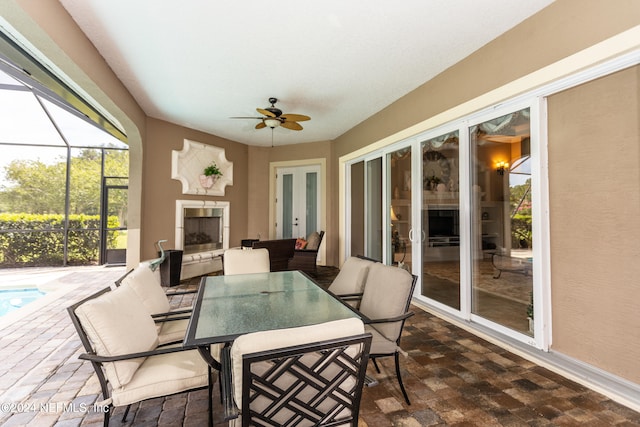 sunroom with ceiling fan and a pool