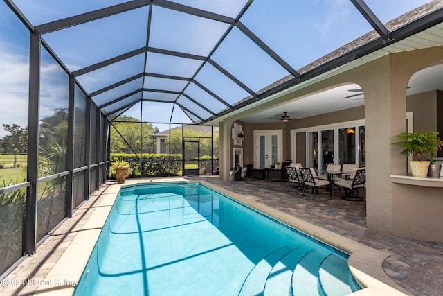 view of pool featuring a lanai, a patio area, ceiling fan, and french doors